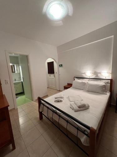a bedroom with a bed with two towels on it at Alexandra’s studios in Iraklia