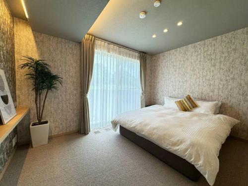 Una cama o camas en una habitación de Akikawa Koshi 4