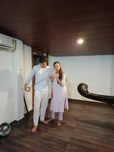 a man and a woman standing in a room at Haven Stay Manor in Kotamangalam
