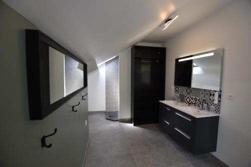 a bathroom with a sink and a mirror at Hôtel Le Bayeux in Bayeux