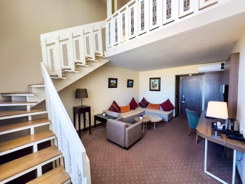 a room with a staircase and a living room at Kenzi Basma in Casablanca