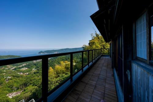 a balcony of a house with a view of the ocean at Suite Villa Ocean View Atami Shizenrou - Japanese style in Atami