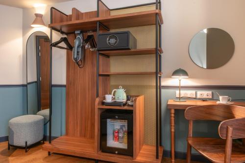 a living room with a tv on a shelf at Hotel Terminus Lyon in Paris