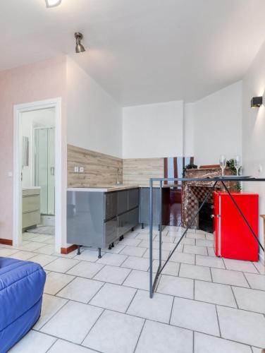 un salon avec un canapé bleu et une cuisine dans l'établissement Samois-sur-seine Superbe appartement - Rickhoss Home, à Samois-sur-Seine