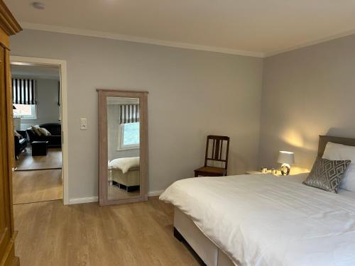 a bedroom with a large bed and a mirror at Gestorfer Kötnerhof Business und Landlust in Springe