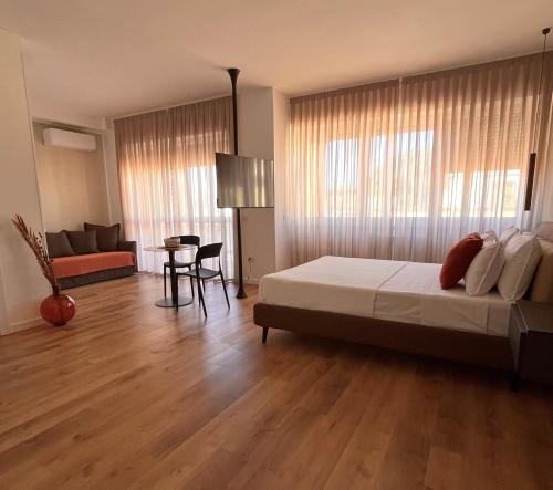 a bedroom with a bed and a living room at Binario9 in Lecce