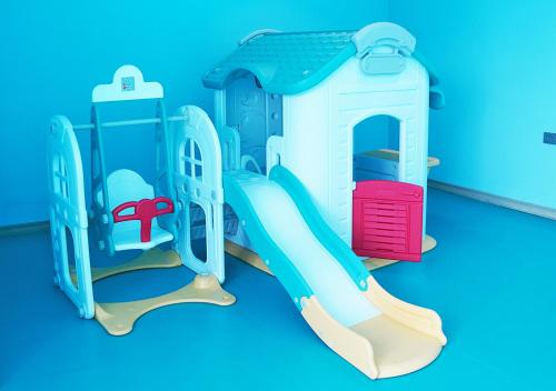 a playset with a slide on a blue background at Farhan Tower in Juffair