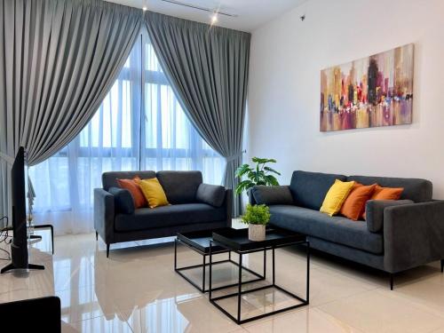 a living room with two couches and a table at Paradigm Residence Johor Bahru in Johor Bahru