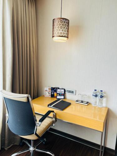 a desk with a chair and a laptop on it at The Fern Residency Sarnath in Varanasi