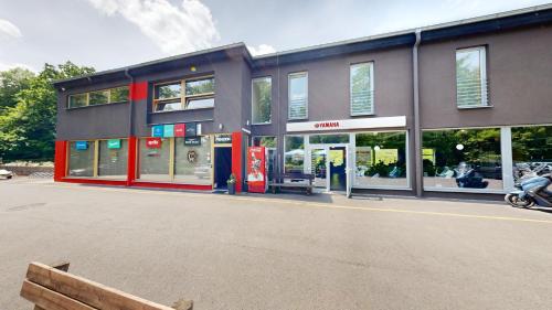 a building with a gas station in front of it at Penzion ER1 in Zlín
