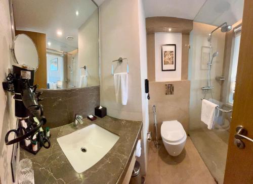 a bathroom with a sink and a toilet at The Fern Residency Sarnath in Varanasi