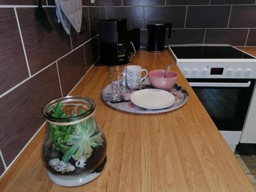 a kitchen counter with a table with a plate and a vase at 4 beds furnished apartment at prime location Hudiksvall in Hudiksvall