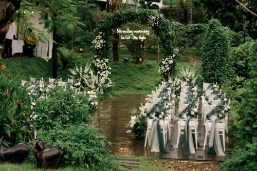 a table set up for a wedding in a garden at aNhill Boutique in Hue
