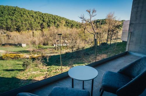a room with a window with a table and chairs at Pachán Dehesa Boyal in Cuenca