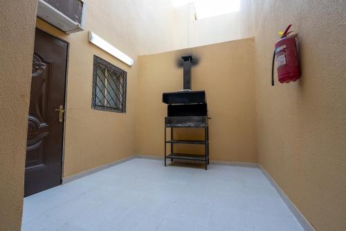 a hallway with a room with a fire extinguisher at Rawafed resort in Taif