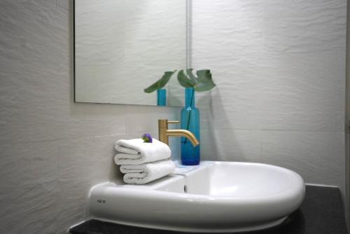a white sink in a bathroom with towels at LOVE beach club Koh Samui in Chaweng