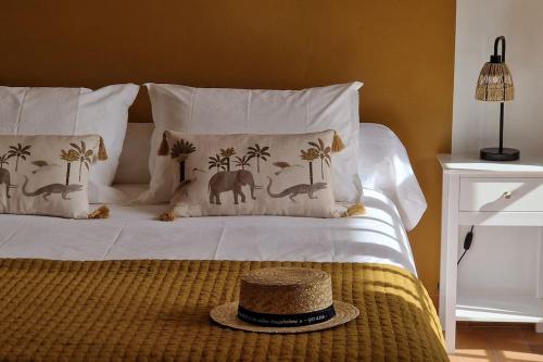 un lit avec un chapeau installé au-dessus dans l'établissement Magnifique maison provençale haut standing avec piscine, jardins, garages fermés, à Sablet