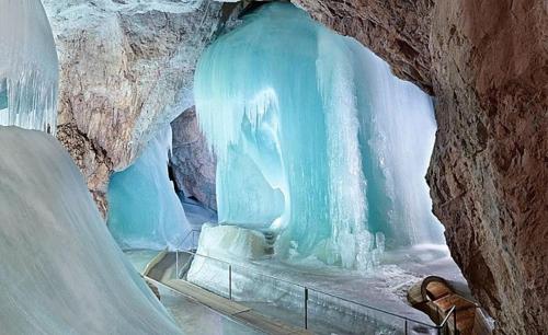 a person standing in front of an ice cave at Hotel Forsthof in Sankt Johann im Pongau