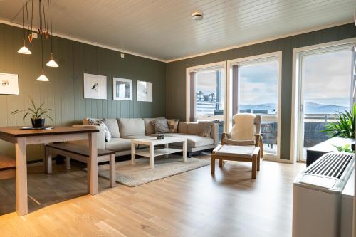 a living room with a couch and a table at Voss Resort self-service apartments in Skulestadmo
