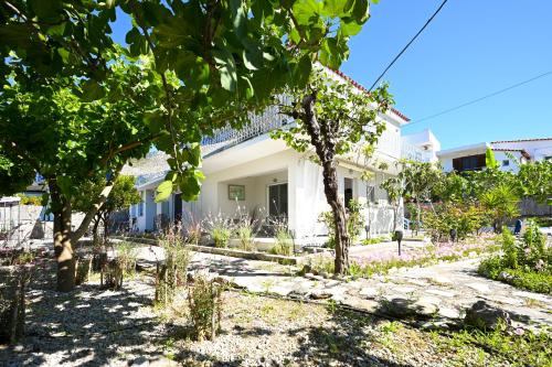 a house with a garden in front of it at Anchor Villa in Skiathos Town