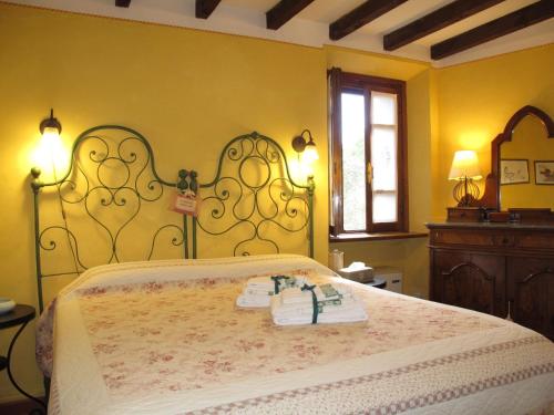 a bedroom with a bed with two towels on it at Apartment di Magnano by Interhome in Diolo