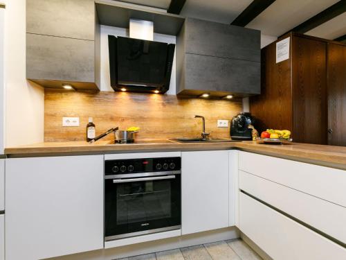 a kitchen with a stove and a tv on the counter at Apartment Residenza Chesa Margun 14-7 by Interhome in Surlej