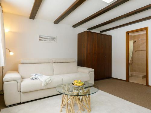 a living room with a couch and a glass table at Apartment Residenza Chesa Margun 35-1 by Interhome in Surlej