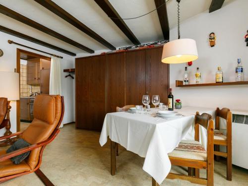 a dining room with a white table and chairs at Apartment Residenza Chesa Margun 34-7 by Interhome in Surlej