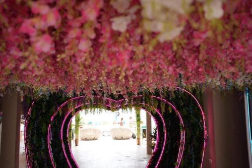 a bunch of pink flowers hanging from a ceiling at LOVE beach club Koh Samui in Chaweng