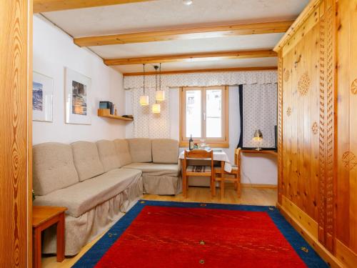 a living room with a couch and a table at Studio Residenza Chesa Margun 34-4 by Interhome in Surlej