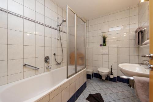 a bathroom with a shower and a sink and a toilet at Apartmenthaus Goldeck in Ried im Oberinntal