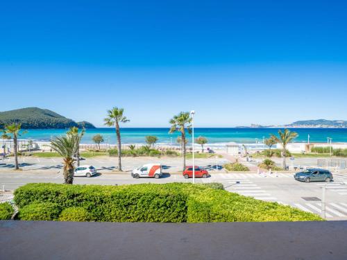 - une vue sur un parking avec des palmiers et l'océan dans l'établissement Apartment La Sirene-3 by Interhome, aux Lecques