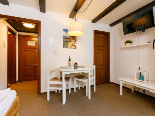 a dining room with a white table and chairs at Apartment Residenza Chesa Margun 13-2 by Interhome in Surlej