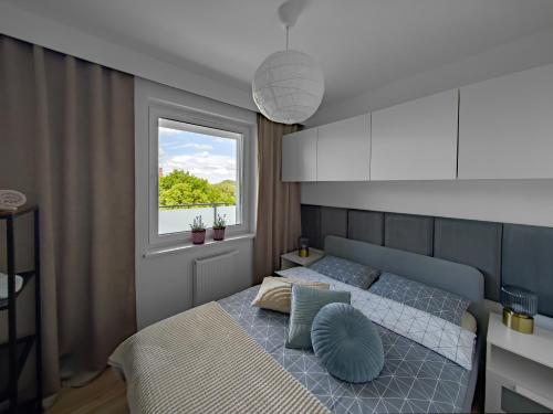 a bedroom with two beds and a window at NOWOCZESNY APARTAMENT MODERNO 2020 - Szczecinek in Szczecinek