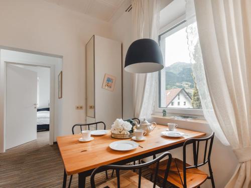a dining room with a table and chairs and a window at Apartment Kern by Interhome in Bad Hofgastein