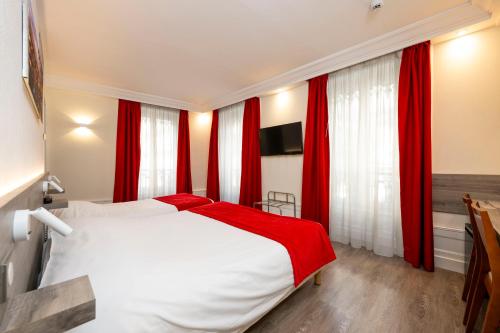 a bedroom with red curtains and a white bed at La Résidence in Lyon