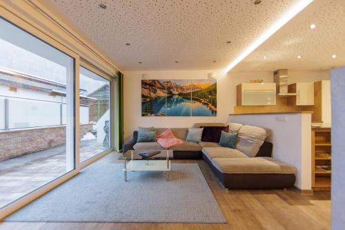 a living room with a couch and a table at Apartmenthaus Goldeck in Ried im Oberinntal