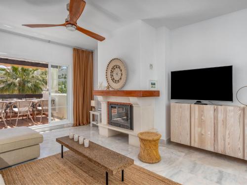 a living room with a tv and a fireplace at Apartment Las Adelfas by Interhome in Marbella