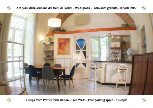 a kitchen and dining room with a table and chairs at PORTICI - Casa con Posto Auto Gratuito e Wi-Fi a 2 passi dalla Circumvesuviana e a 10 minuti dal mare in Portici