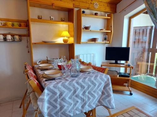 une salle à manger avec une table et une télévision dans l'établissement Apartment Martagon-2 by Interhome, à Saint-Gervais-les-Bains