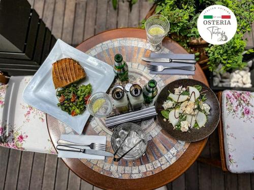 a table with a plate of food and a sandwich at Urban Eden - LUX & STYLE, 2-Bedroom, 2-Bathroom in Sofia