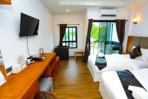 a hotel room with two beds and a television at My Memory Mueang Loei in Loei