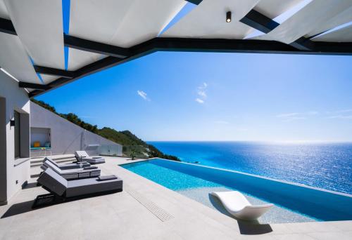 a swimming pool with a view of the ocean at Aeliades Villas in Agios Nikitas