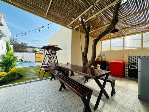 a patio with a wooden bench and a tree at MON House in Ấp Sung Xuân