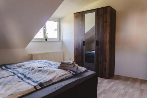 a bedroom with a bed and a mirror on the wall at Dogern in Luttingen
