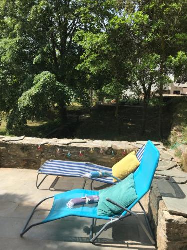 a blue lounge chair sitting on a patio at Cozy Hide Away Frantato in Akamatra