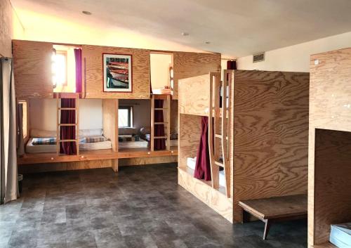a room with wooden walls and shelves and a room with a room at Ostal Île de Batz - Auberge de jeunesse in Île de Batz