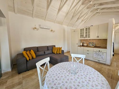 a living room with a couch and a table at Kövirózsa Porta in Mindszentkálla
