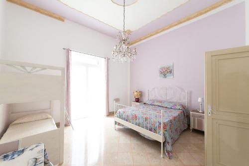 Letto o letti in una camera di Palazzo Marchese Milo