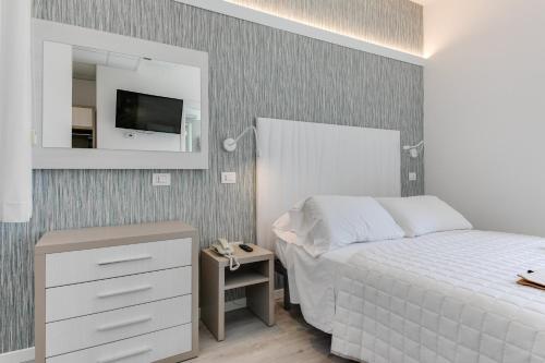 Letto o letti in una camera di MARITTIMO Milano Marittima